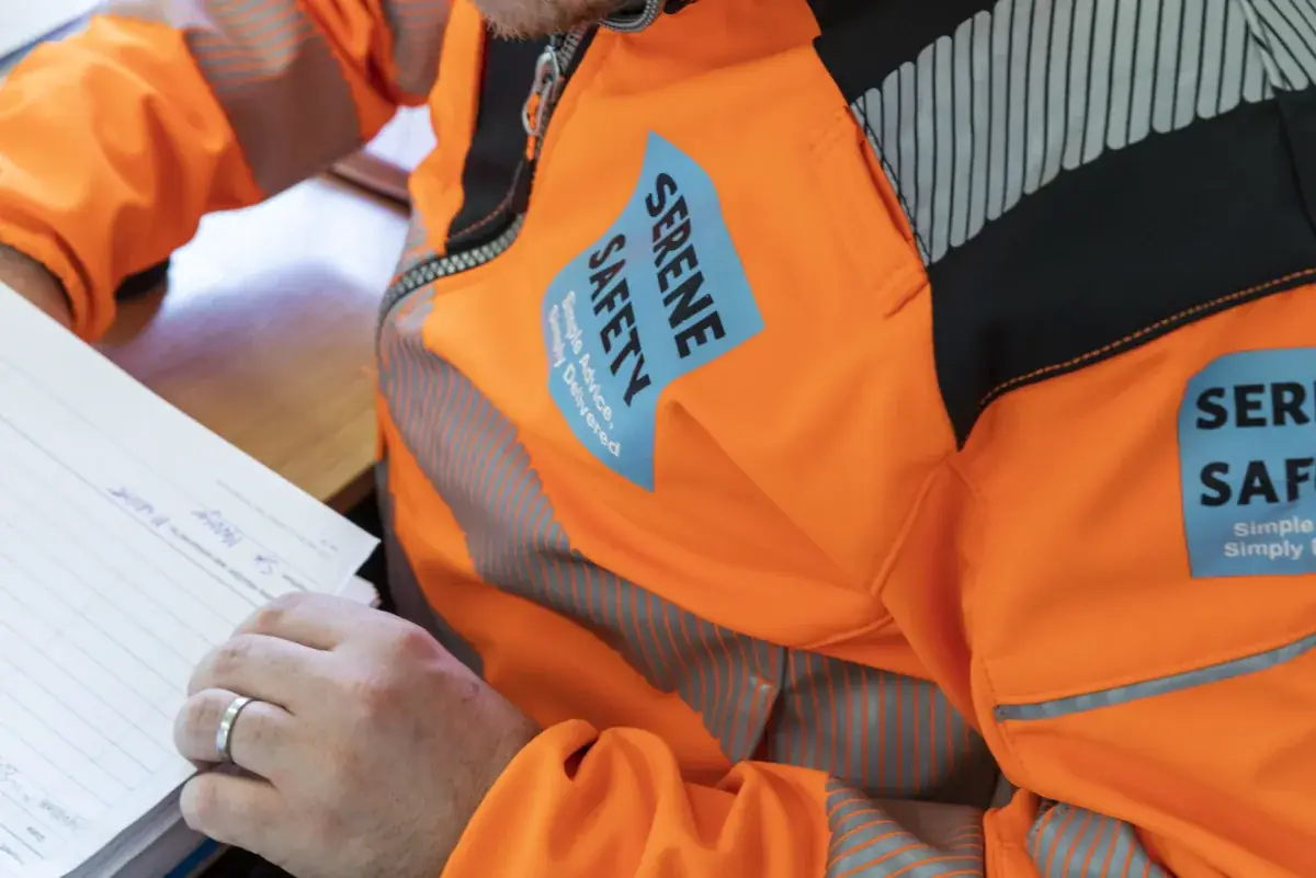 Auditor reviewing workplace safety documentation