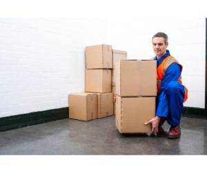 A man lifting boxes, demonstrating manual handling techniques